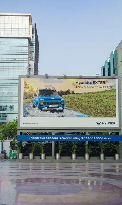 Digital LED billboard displaying an event promotion in central Pune.